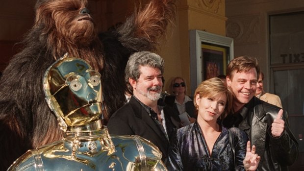 Humour, action, mysticism: Creator George Lucas (centre) and cast members Carrie Fisher and Mark Hamill are joined by characters C-3PO and Chewbacca  at the Hollywood premiere of Star Wars Special Edition in  1997.