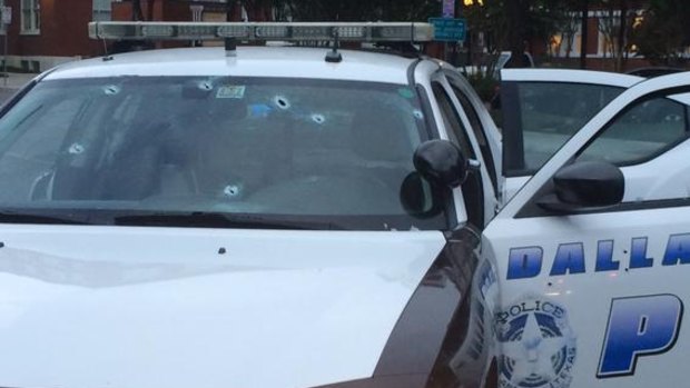 Bullet holes in a police car outside Dallas Police headquarters.