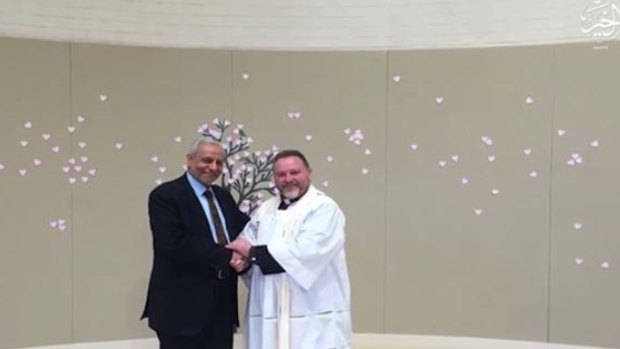 The Grand Mufti, Dr Ibrahim Abu Mohamed, is pictured in the Islamic State video shaking hands with inter-faith advocate and Anglican minister Father Rod Bowers.