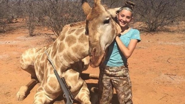 Aryanna Gourdin poses with a giraffe she hunted in South Africa.