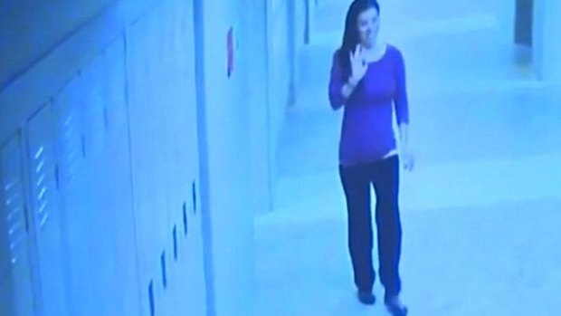 In this screengrab, maths teacher Colleen Ritzer waves in the hall of Danvers High School, moments before she was killed.
