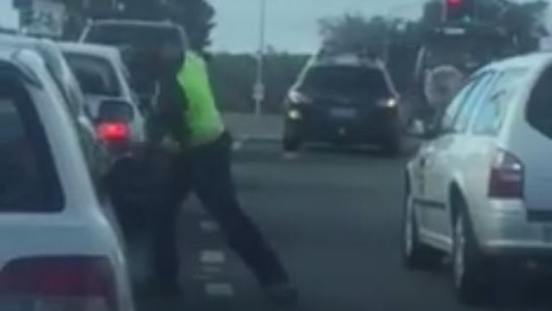 A man punches another driver's car in a bout of road rage in Canberra.