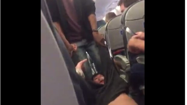 A fellow United passenger's video showed the man being dragged through the aisle.