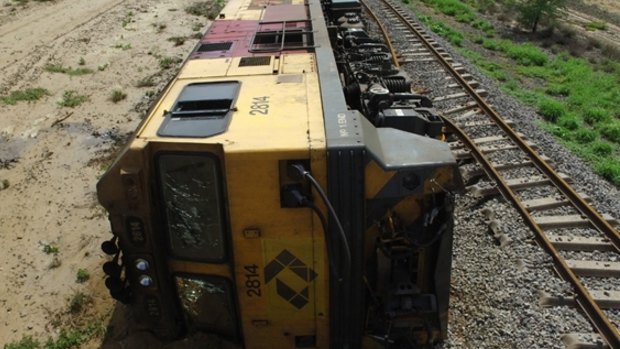 The trains engine lies on its side after the derailment.