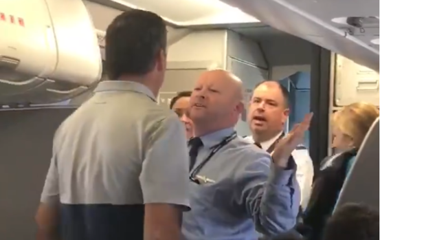 The American Airlines flight attendant can be seen getting into a verbal argument with another passenger.
