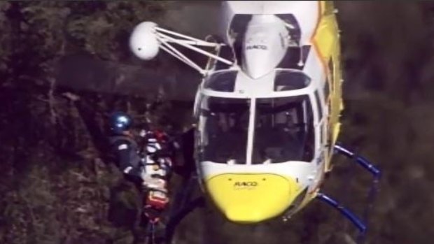 The RACQ rescue helicopter has winched the injured 18-year-old woman off Mount Tibrogargan.