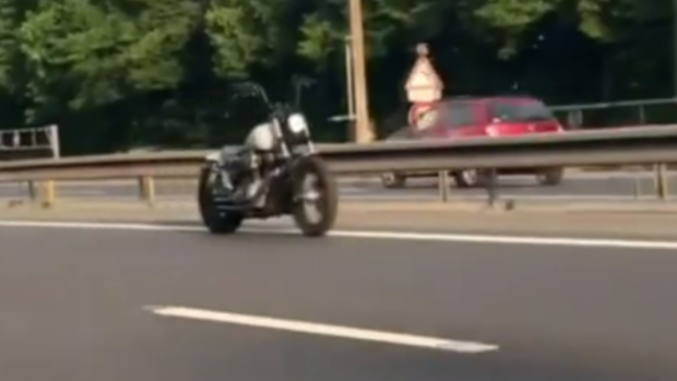 The riderless motorcycle cruising along the motorway.