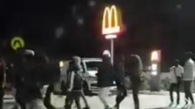 A crowd gathers at the McDonalds in Tarneit on Sunday night.