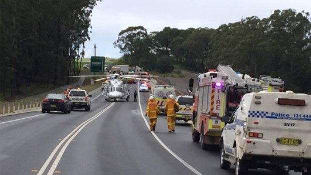 Police and emergency services at the scene of the fatal crash on the Princes Highway. 
