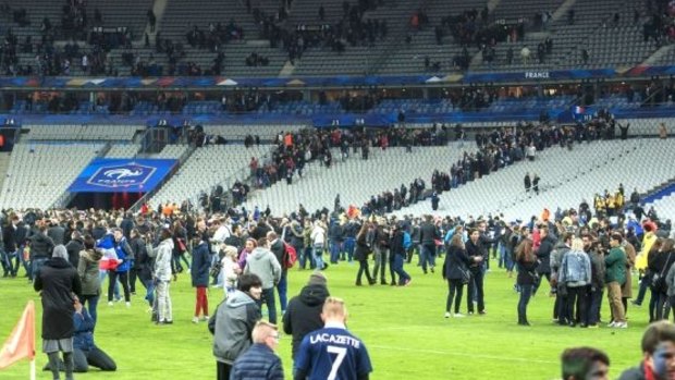 Fans enter the Stade de France pitch for refuge.