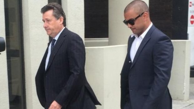 Former Eagle Daniel Kerr (right) arrives at the Perth Magistrates Court for an earlier appearance.