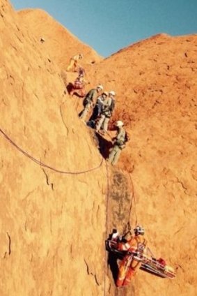 The 27-year-old man was winched up the face of Uluru before being boarded on a helicopter.