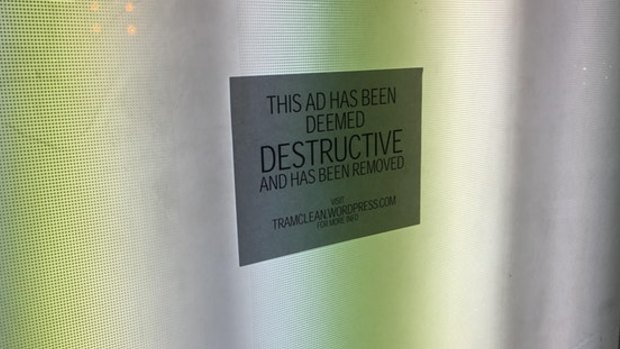 A picture of the sticker at a Flinders Street tram stop.