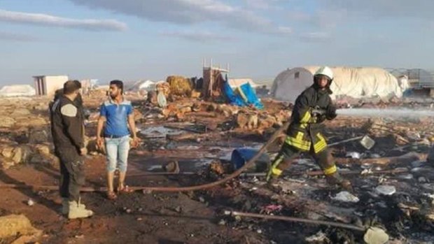 The aftermath of a reported air strike on a refugee camp in Syria.