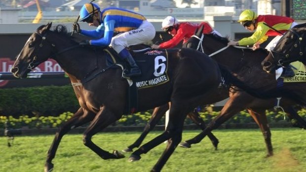 Frenetic race: Bjorn Baker claims his maiden Group 1 with Music Magnate in the Doomben 10000. Picture: Racing Queensland