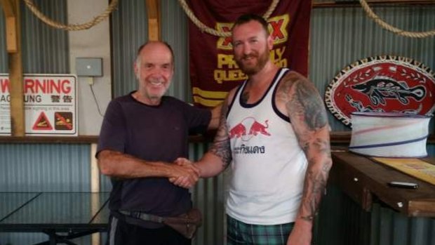 Geoff Keys thanks his rescuer, Senior Constable Brad Foat. Mr Keys was found after writing a plea for help in the sand in Jardine National Park.