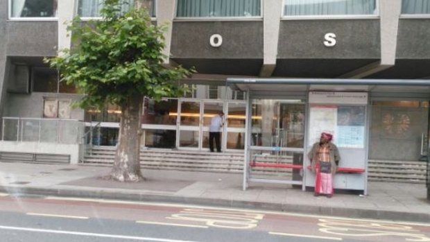 A man cleaning the window of the Polish Community Centre in Hammersmith in London after someone painted it with the words 'Get out'.