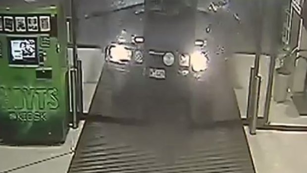 An image from CCTV footage of the LandCruiser smashing through the shopping centre doors.