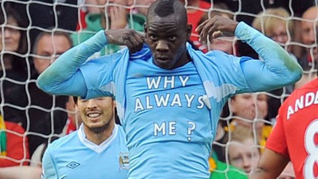 Why always me: Balotelli after scoring against Manchester United at Old Trafford in 2011.
