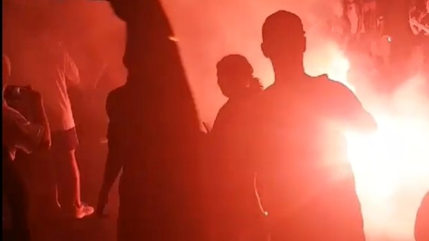 A flare is lit at the Melbourne derby on Saturday night.