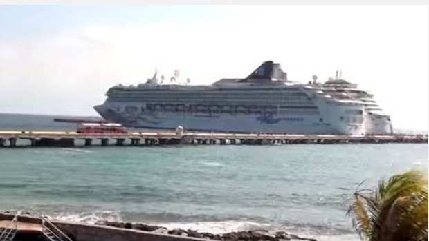 A rock "island" will be created to protect cruise liners moored to an offshore pier, like this example in Mexico.