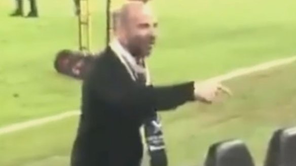 George Calombaris exchanges words with a fan at the A-League grand final.