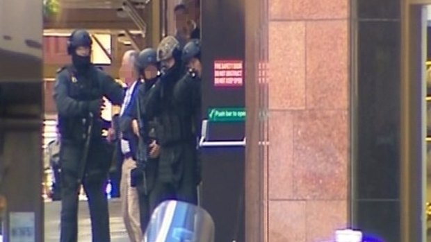 A screenshot from Channel Seven of tactical police as hostages leave the Lindt cafe.