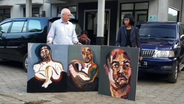 Australian lawyer Julian McMahon with three self-portraits by Sukumaran: "The 72 hours just started", "Strange Day" and "Our new prints: A bad sleep last night".