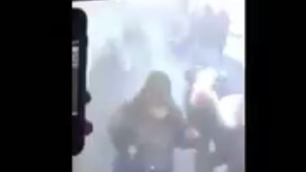 CCTV footage from Port Authority subway shows a plume of smoke and bystanders running for the exits.