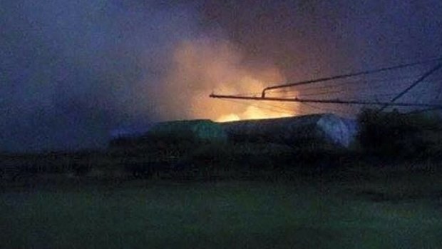 Hay bails burn near Childers on Friday night after a lightning strike.