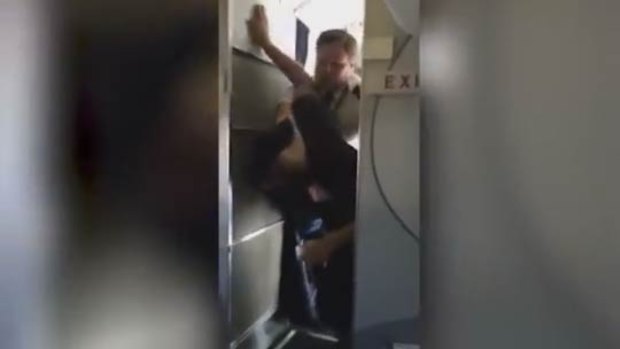 "You don't put your hands on my flight attendant!" the pilot said before taking on the unruly passenger. 