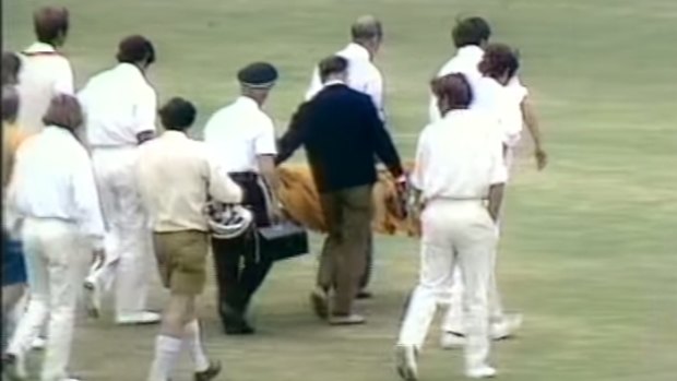 Ewen Chatfield is taken from the field after being struck by a bouncer from Peter Lever.