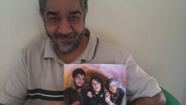 Late Iranian asylum seeker Ali Rahimi, with a photograph of his family. Mr Rahimi died at Villawood detention centre of heart failure in 2012. 