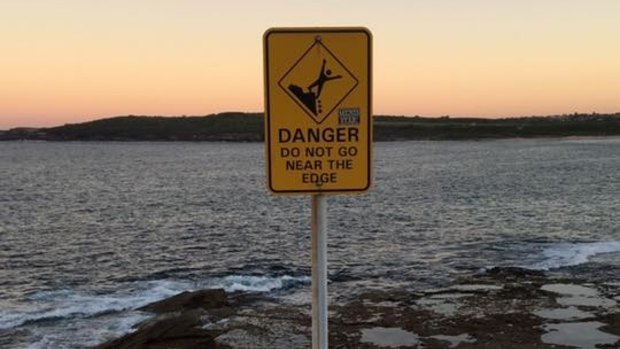 Danger sign on a headland at Maroubra Beach. 