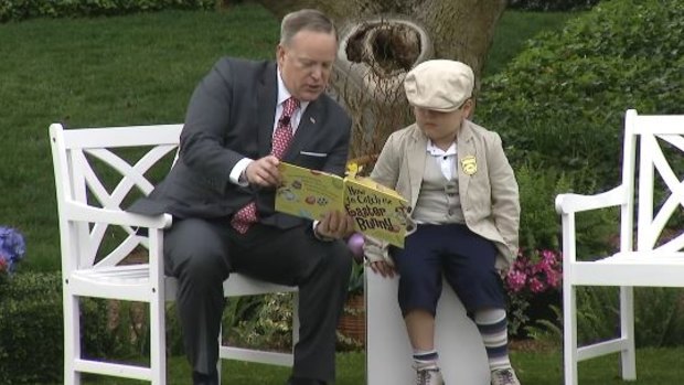 Sean Spicer reading How to Catch the Easter Bunny with the help of a young volunteer. 