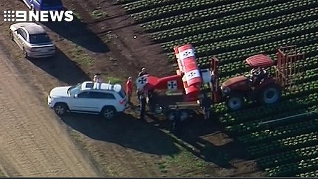 Emergency crews respond to reports that a light plane crash landed in a lettuce field near Gatton.
