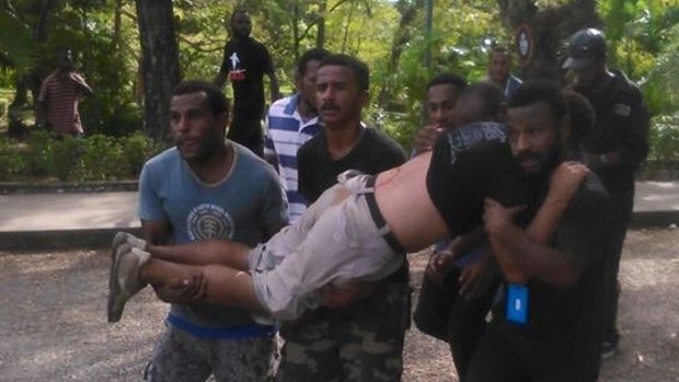A protester is carried away after the shooting at University of Papua New Guinea on Wednesday.