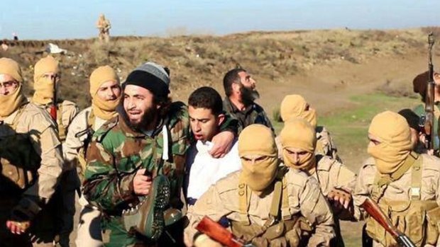 Islamic State militants with captured Jordanian pilot  Muath al-Kasasbeh.