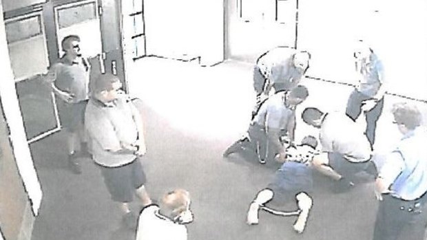CCTV images appear to show a teenager with ankle-cuffs being held down at the Townsville centre.