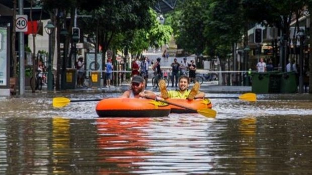 Keiran Beaumont and Sonny Grebe from Redcliffe, paddle their way through the Brisbane CBD.
