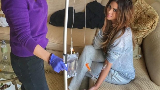 Model Carla DiBello receives an intravenous shot she says 'kills' her jetlag.