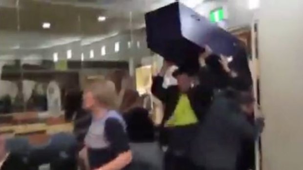 Far-right protesters disrupt Moreland's council meeting brandishing a fake coffin.