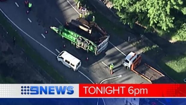 A truck and trailer carrying an excavator has rolled on the Mount Lindesay Highway at Browns Plains