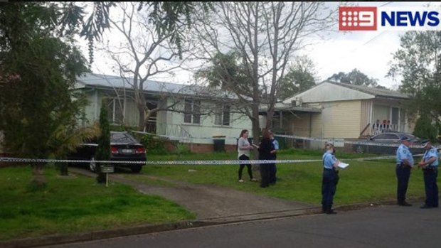 Police at the home in Miller, where a two-year-old girl was found dead on Tuesday. 