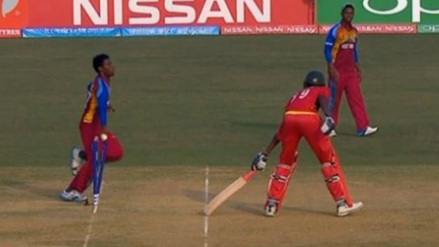 Tricky: Keemo Paul runs out Zimbabwean batsman Richard Ngarava.