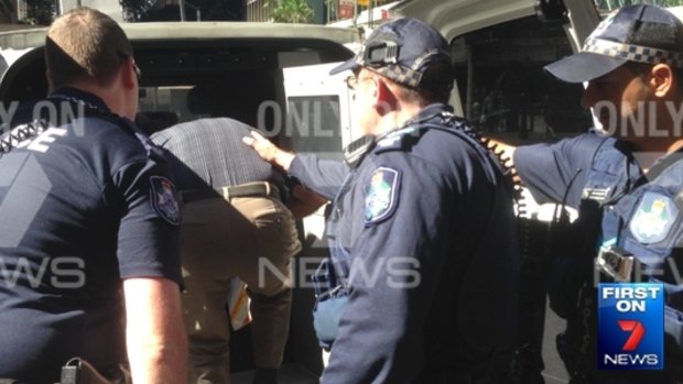 Police detain Mr Di Iorio after over the alleged flag burning.