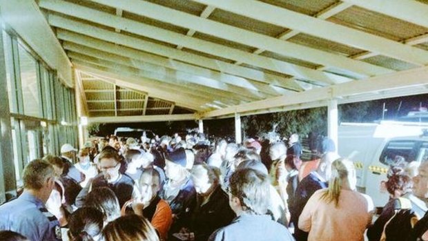 Hundreds of residents gather at the police control point at the Warradale Community Centre after midnight to join the search.