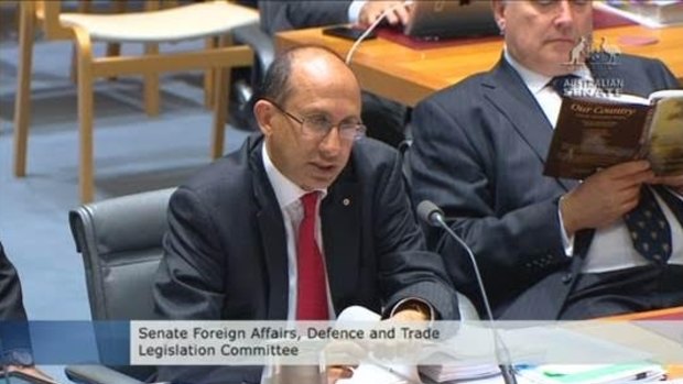 Senator Brandis reads poetry while Department of Foreign Affairs and Trade secretary Peter Varghese answers questions.