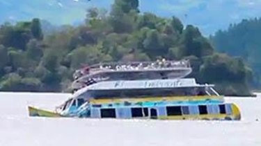 The El Almirante ferry sinks below the surface of the Guatape reservoir.