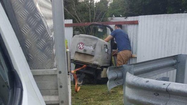 A man was pinned between a mower and a fence beam at a service station in Deagon.